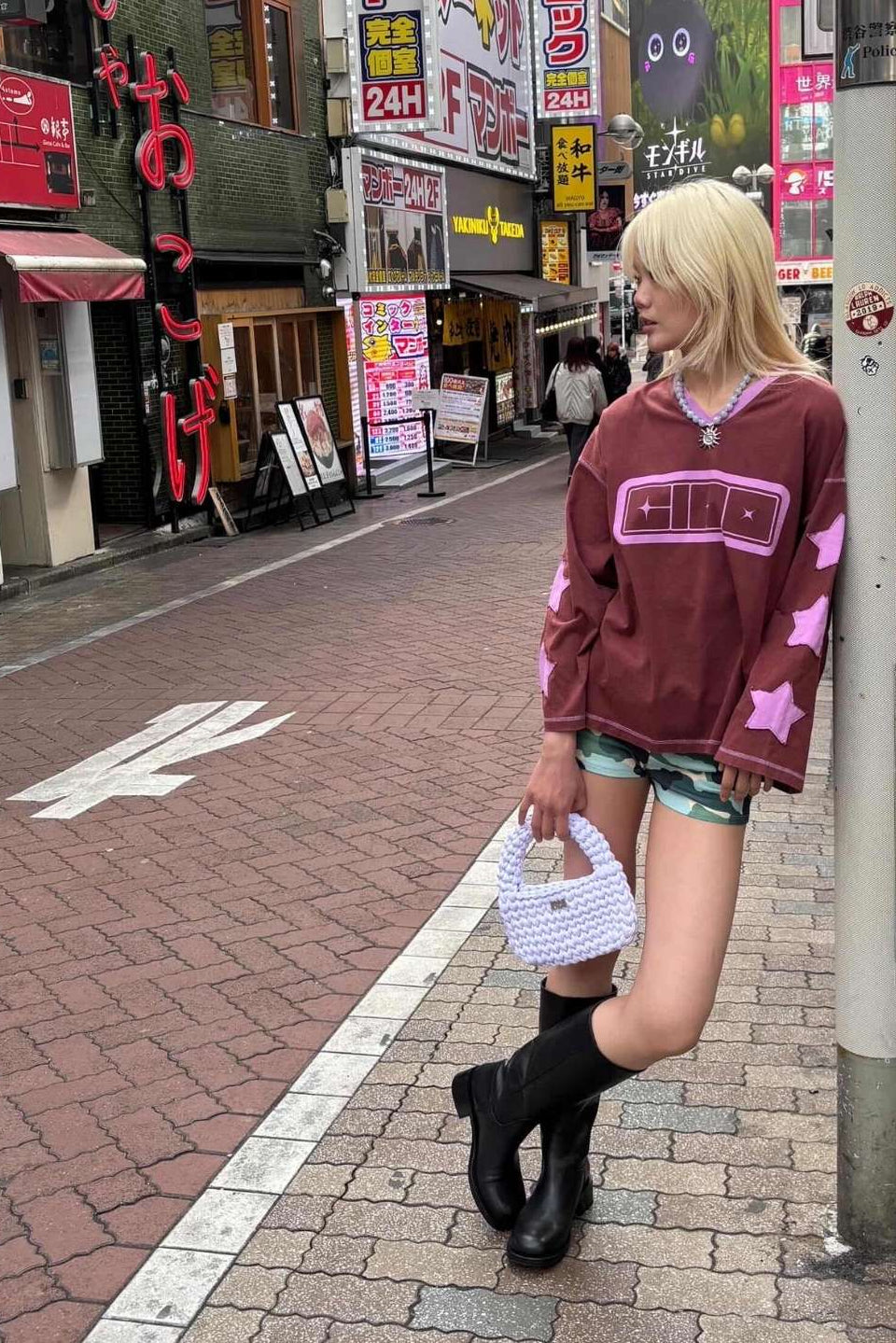 A white crocheted hand bag styled by CIAOCIAO in the Tokyo Streets