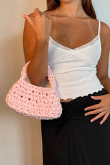Woman Wearing A Baby Pink Clutch Bag