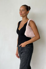 Beatiful Woman Wearing An Evening Baby Pink Bag With Black Outfit