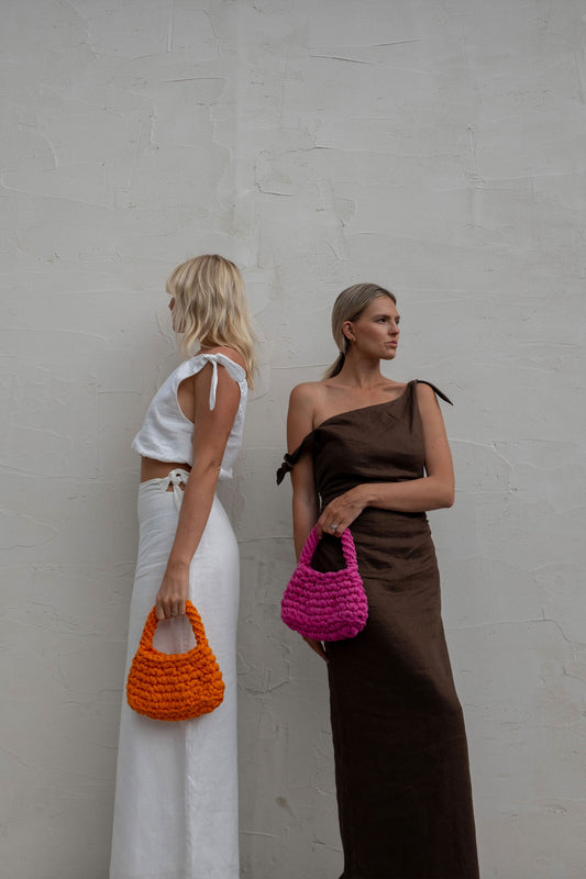 Two Women Wearing The Volcan Mini Bags 
