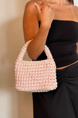 Woman With A Crafted Baby Pink Mini Bag In Her Arm